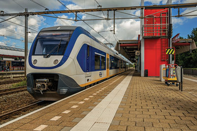 Locomotive stop on train station platform at weesp. a pleasant small village in netherlands.