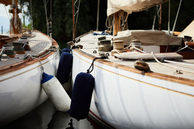 Close-up of boats moored in row