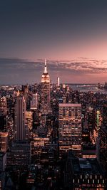 Illuminated cityscape against sky at night