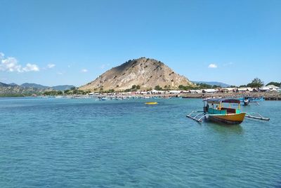 Scenic view of bay against clear blue sky