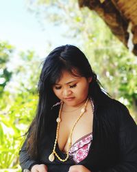 Woman looking down while standing outdoor