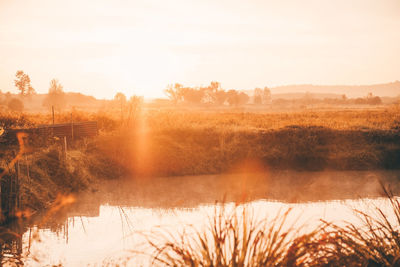 Scenic view of lake against sky during sunset