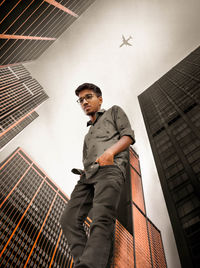 Low angle view of man standing against building