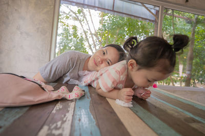 Girl and woman lying on floor