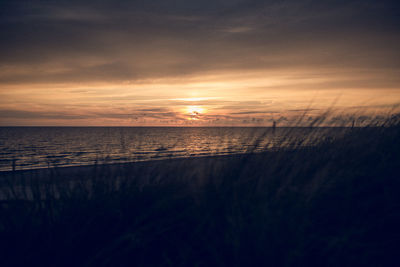 Scenic view of sea against sky at sunset