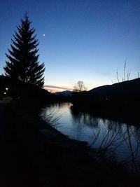 Scenic view of lake against sky at sunset