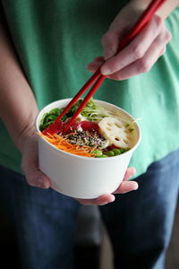 Close-up of hand holding bowl