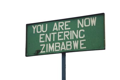 Close-up of road sign against white background