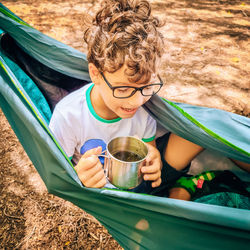 High angle view portrait of boy drinking water