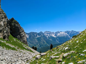 Rear view of man with backpack standing on mountain