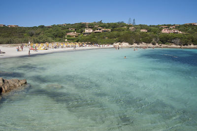 Scenic view of beach against clear blue sky