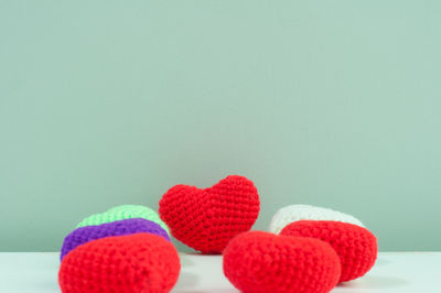 Close-up of heart shape on table against wall