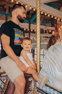 Portrait of smiling young woman sitting on sofa at home