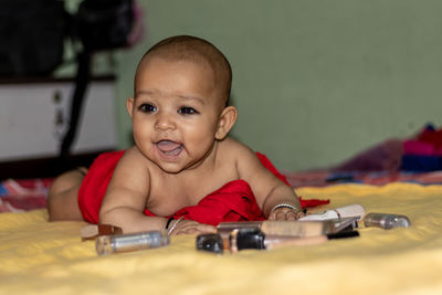 Portrait of cute baby girl on table