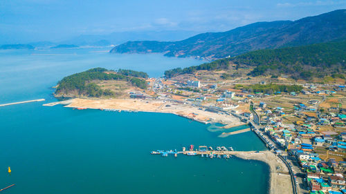 High angle view of sea and mountains against sky