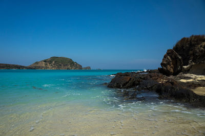 Scenic view of sea against clear blue sky