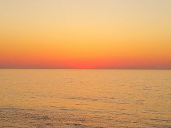 Scenic view of sea against clear sky during sunset