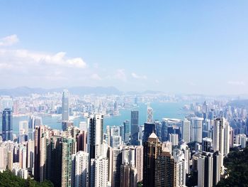 Modern buildings and victoria harbor against sky