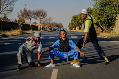 People on road against trees in city