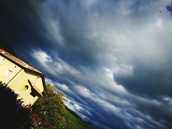 Low angle view of house against cloudy sky