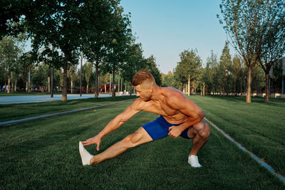 Low section of woman exercising on field