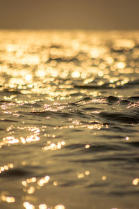 Close-up of sea against sky during sunset
