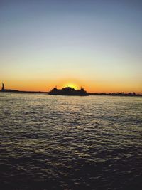 Scenic view of sea against clear sky during sunset