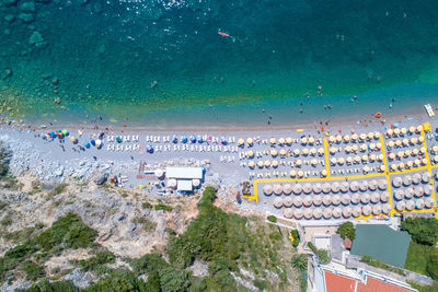 High angle view of crowd by sea against buildings in city