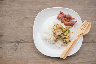 High angle view of fried pork with rice served on table