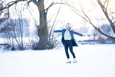 Full length of senior woman walking on snow field