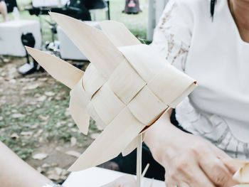 Midsection of woman sitting by craft product