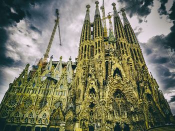 Low angle view of church against cloudy sky