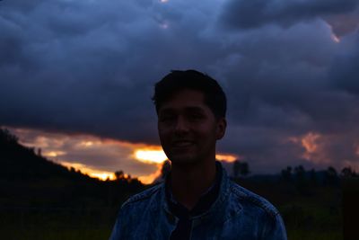 Portrait of young man against sky during sunset