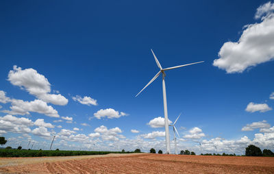 Landscape of windmills for electric power production with white cloud and blue sky at huai bong,