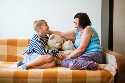 Couple sitting on sofa at home