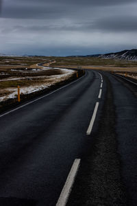 Empty road against sky