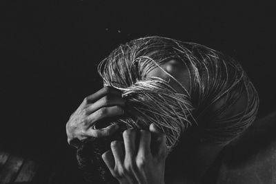 Close-up of woman hand against black background