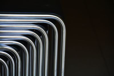 Close-up of metal grate against black background