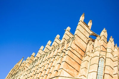 Low angle view of building against blue sky