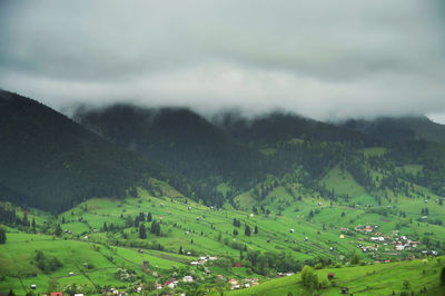 Scenic view of mountains against cloudy sky