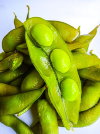 Close-up of green chili pepper against white background