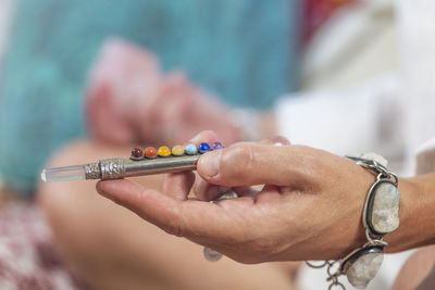 Close-up of woman holding object