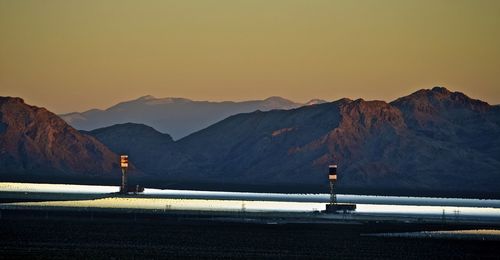 Scenic view of mountains against sky at sunset