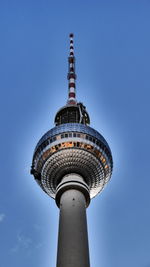 Low angle view of tower and building against sky