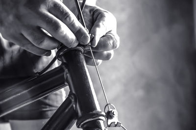 Close-up of hand holding bicycle