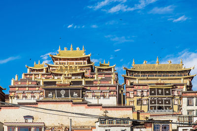 Low angle view of buildings against blue sky