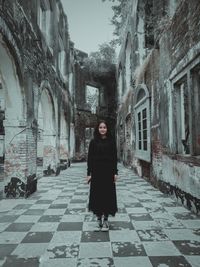 Full length of woman standing on old building