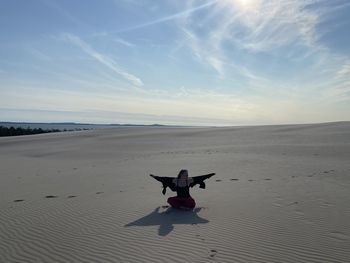 Scenic view of person on beach against sky