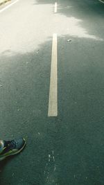 Low section of person standing on road