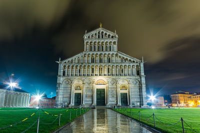 Illuminated building against sky at night